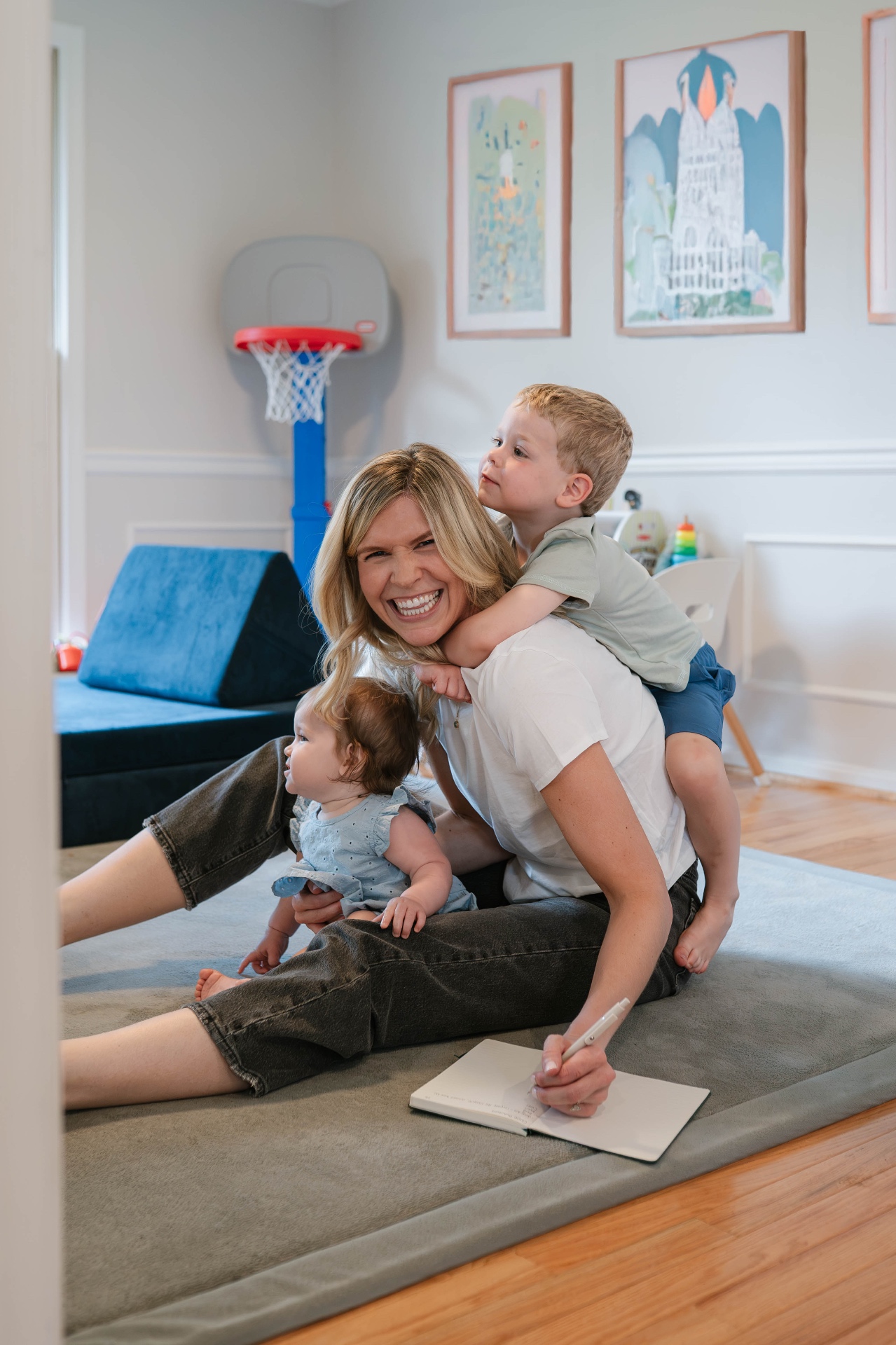 Carole playing on the floor with her two young children